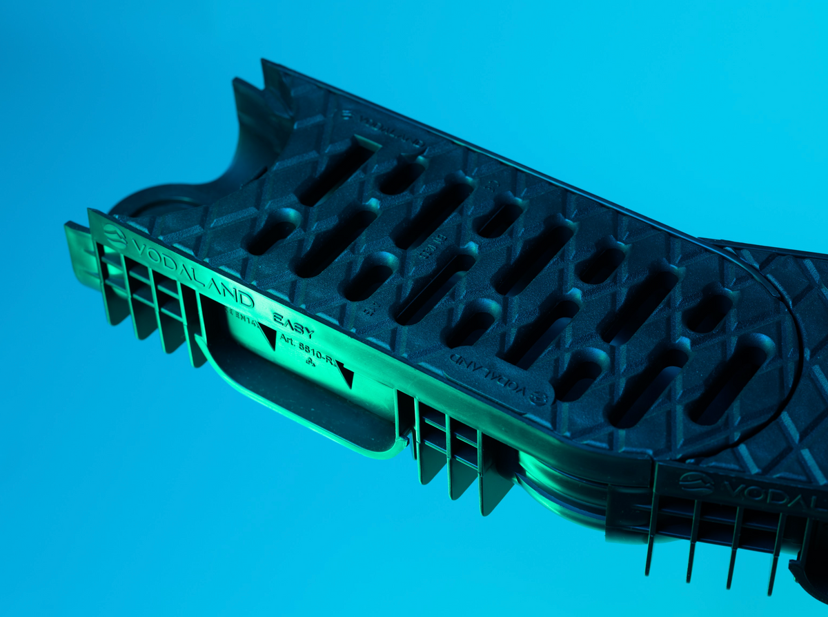 Black Plastic Channel Drain on Blue Background